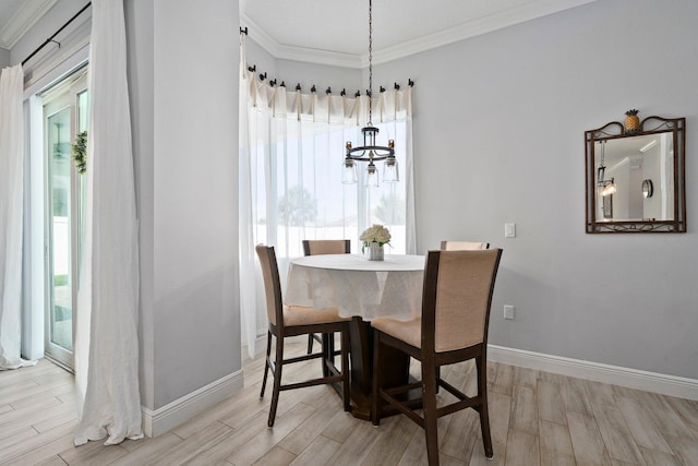 979 SW Mcdevitt Ave, Port Saint Lucie, FL 34953 - dining area with light wood-style floors, baseboards, crown molding, and a chandelier