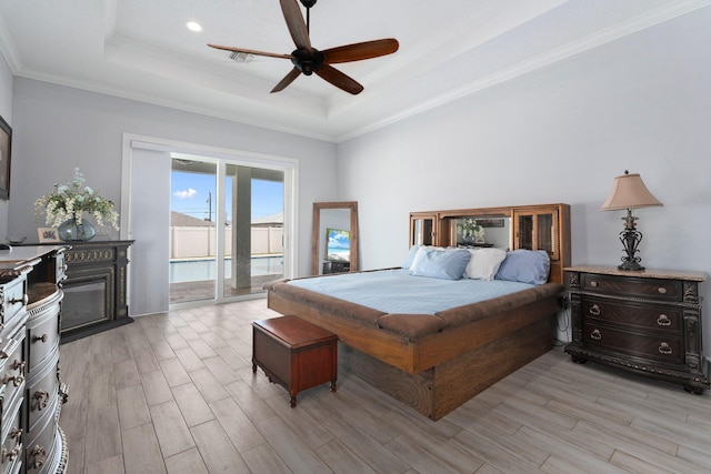 979 SW Mcdevitt Ave, Port Saint Lucie, FL 34953 - bedroom featuring a tray ceiling, access to outside, light wood-type flooring, crown molding, and a ceiling fan
