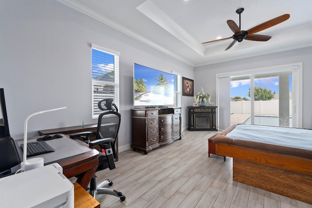 979 SW Mcdevitt Ave, Port Saint Lucie, FL 34953 - bedroom with a raised ceiling, crown molding, multiple windows, access to exterior, and light wood-style floors