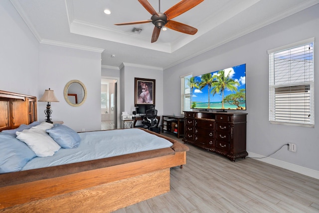 979 SW Mcdevitt Ave, Port Saint Lucie, FL 34953 - bedroom with a tray ceiling, light wood-style flooring, baseboards, ceiling fan, and crown molding