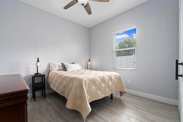 979 SW Mcdevitt Ave, Port Saint Lucie, FL 34953 - bedroom featuring baseboards, light wood-type flooring, and a ceiling fan