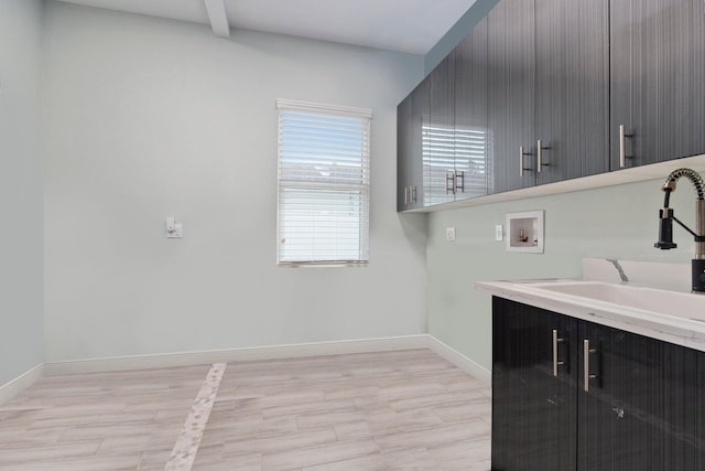 979 SW Mcdevitt Ave, Port Saint Lucie, FL 34953 - washroom with washer hookup, cabinet space, and baseboards