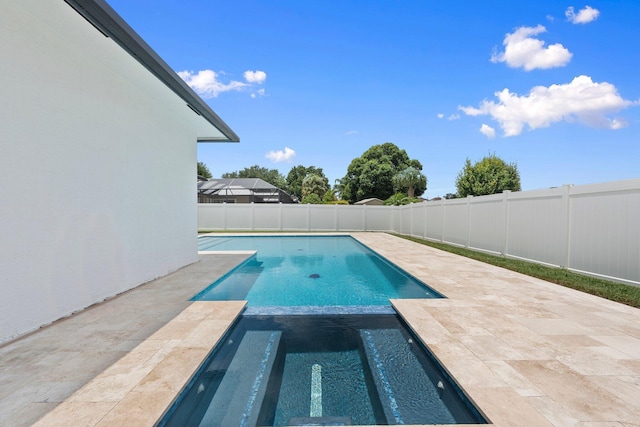 979 SW Mcdevitt Ave, Port Saint Lucie, FL 34953 - view of pool featuring a fenced backyard, a patio area, and a pool with connected hot tub
