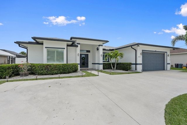 979 SW Mcdevitt Ave, Port Saint Lucie, FL 34953 - prairie-style home featuring stucco siding, an attached garage, and concrete driveway