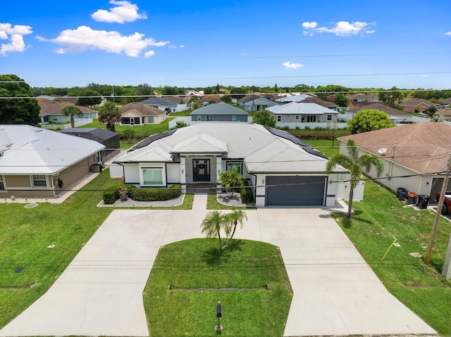 979 SW Mcdevitt Ave, Port Saint Lucie, FL 34953 - ranch-style house featuring a residential view, concrete driveway, an attached garage, and stucco siding
