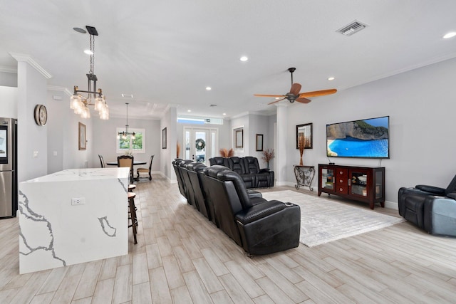 979 SW Mcdevitt Ave, Port Saint Lucie, FL 34953 - living room with crown molding, light wood-type flooring, recessed lighting, a chandelier, and baseboards