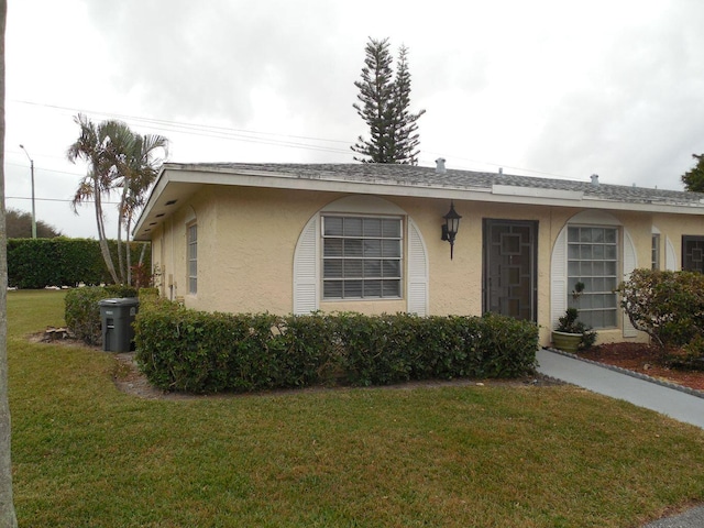 13907 Via Aurora Unit A, Delray Beach, FL 33484 - view of front facade featuring stucco siding and a front yard