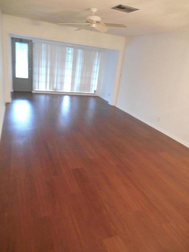 13907 Via Aurora Unit A, Delray Beach, FL 33484 - unfurnished room with dark wood finished floors, a ceiling fan, and baseboards