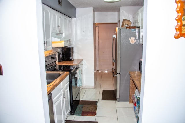 3821 Environ Blvd Unit 203, Lauderhill, FL 33319 - kitchen featuring stainless steel appliances, white cabinets, light tile patterned flooring, and range hood