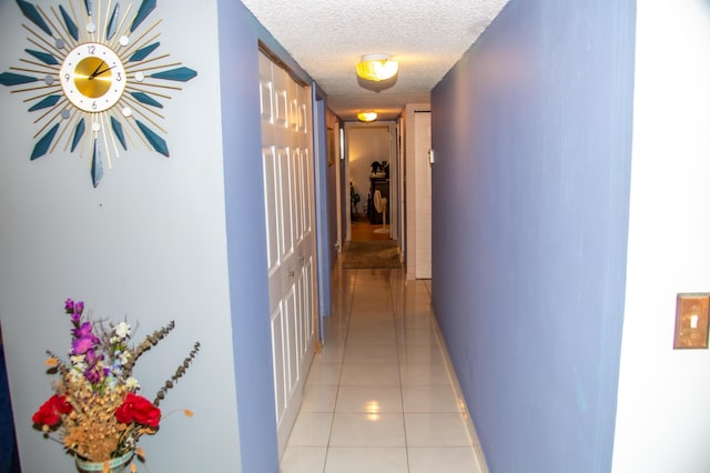 3821 Environ Blvd Unit 203, Lauderhill, FL 33319 - hallway with a textured ceiling, light tile patterned floors, and baseboards
