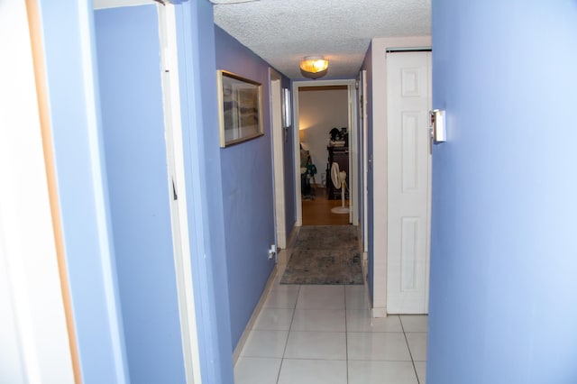 3821 Environ Blvd Unit 203, Lauderhill, FL 33319 - hallway with a textured ceiling, baseboards, and light tile patterned floors