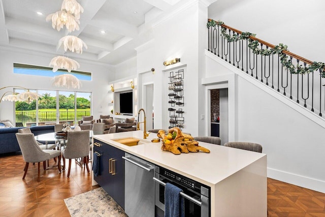 107 SE Santa Gardenia, Port Saint Lucie, FL 34984 - kitchen featuring open floor plan, a high ceiling, dishwasher, a sink, and wall oven