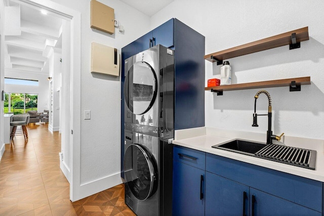 107 SE Santa Gardenia, Port Saint Lucie, FL 34984 - washroom featuring stacked washing machine and dryer, a sink, and baseboards
