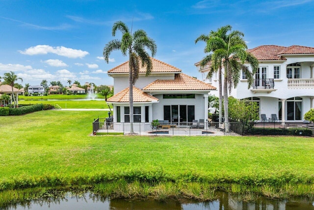 107 SE Santa Gardenia, Port Saint Lucie, FL 34984 - back of property featuring stucco siding, a tiled roof, a water view, and a patio area