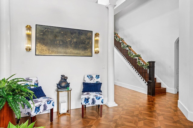 107 SE Santa Gardenia, Port Saint Lucie, FL 34984 - sitting room with stairway, arched walkways, baseboards, and decorative columns