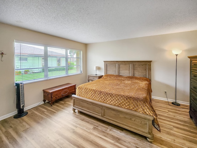 1744 Lakefront Blvd Unit C, Fort Pierce, FL 34982 - bedroom with a textured ceiling, light wood-type flooring, and baseboards