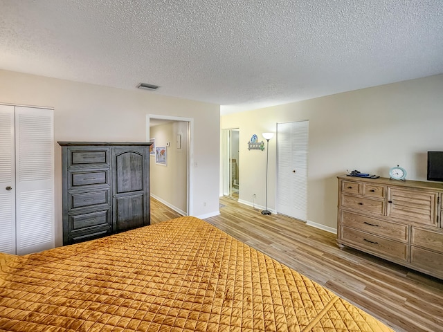 1744 Lakefront Blvd Unit C, Fort Pierce, FL 34982 - unfurnished bedroom featuring wood finished floors, baseboards, and a textured ceiling