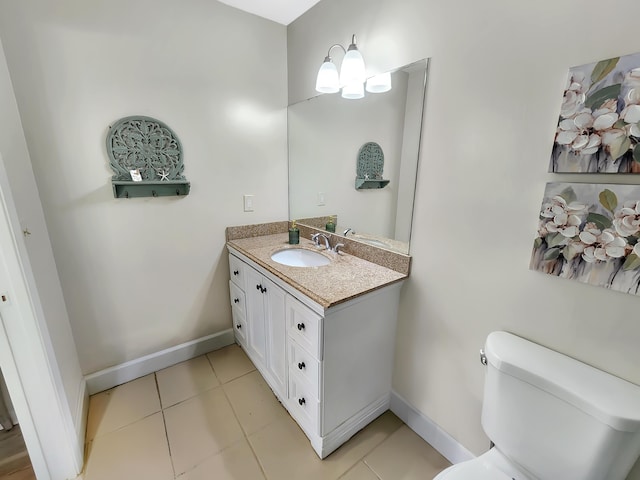 1744 Lakefront Blvd Unit C, Fort Pierce, FL 34982 - half bathroom with vanity, toilet, tile patterned flooring, and baseboards