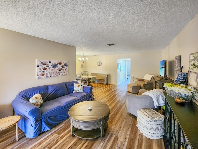 1744 Lakefront Blvd Unit C, Fort Pierce, FL 34982 - living room featuring a chandelier, wood finished floors, and a textured ceiling