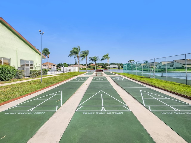 1744 Lakefront Blvd Unit C, Fort Pierce, FL 34982 - surrounding community featuring shuffleboard, a tennis court, and a residential view