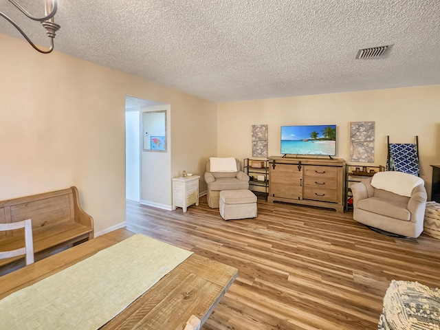1744 Lakefront Blvd Unit C, Fort Pierce, FL 34982 - sitting room with wood finished floors, a textured ceiling, and baseboards