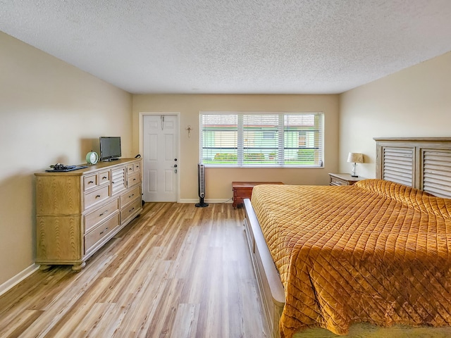 1744 Lakefront Blvd Unit C, Fort Pierce, FL 34982 - bedroom featuring light wood-style floors, baseboards, and a textured ceiling