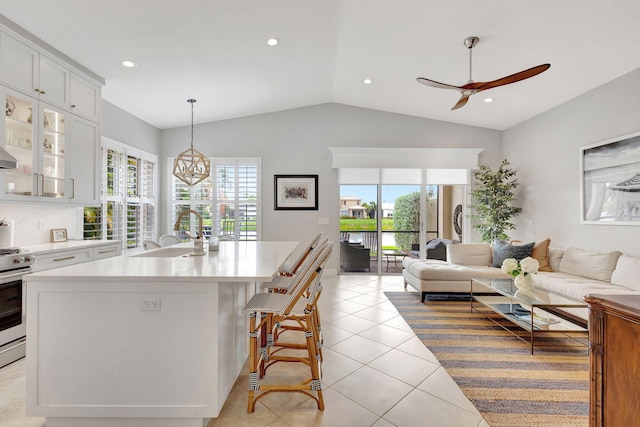 202 Isle Verde Way, Palm Beach Gardens, FL 33418 - kitchen featuring a sink, open floor plan, healthy amount of natural light, vaulted ceiling, and light countertops