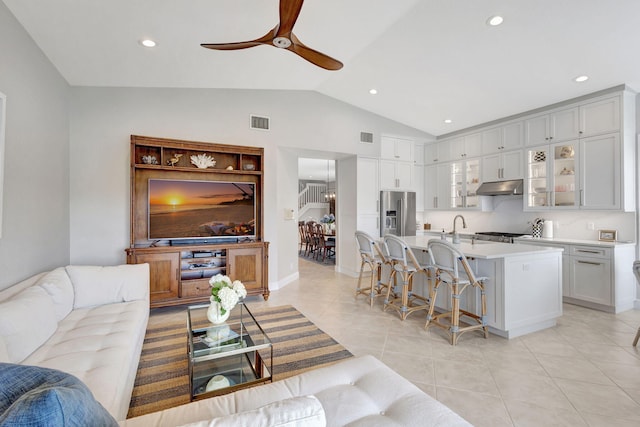 202 Isle Verde Way, Palm Beach Gardens, FL 33418 - living room featuring a ceiling fan, vaulted ceiling, light tile patterned floors, and recessed lighting