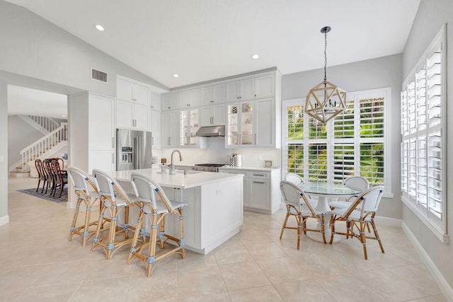 202 Isle Verde Way, Palm Beach Gardens, FL 33418 - kitchen with high end refrigerator, under cabinet range hood, a sink, light countertops, and glass insert cabinets