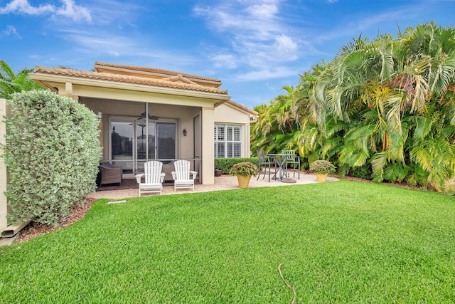 202 Isle Verde Way, Palm Beach Gardens, FL 33418 - back of property with ceiling fan, a patio area, a yard, stucco siding, and a tiled roof