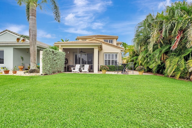 202 Isle Verde Way, Palm Beach Gardens, FL 33418 - rear view of house featuring a sunroom, a lawn, stucco siding, a patio, and ceiling fan