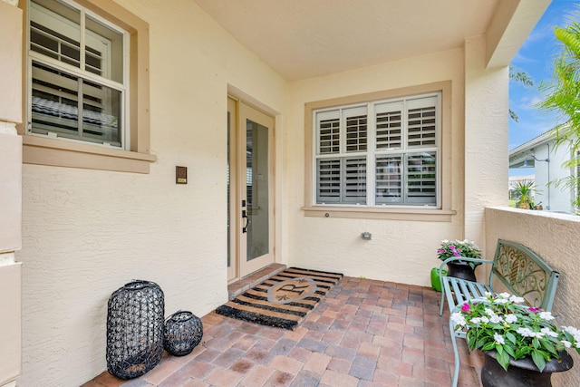 202 Isle Verde Way, Palm Beach Gardens, FL 33418 - view of exterior entry featuring stucco siding