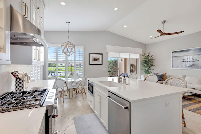 202 Isle Verde Way, Palm Beach Gardens, FL 33418 - kitchen featuring appliances with stainless steel finishes, under cabinet range hood, a sink, a breakfast bar area, and vaulted ceiling