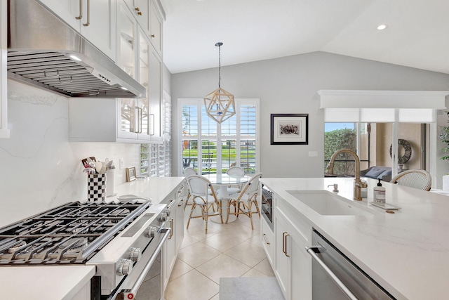 202 Isle Verde Way, Palm Beach Gardens, FL 33418 - kitchen featuring extractor fan, appliances with stainless steel finishes, a sink, decorative light fixtures, and vaulted ceiling