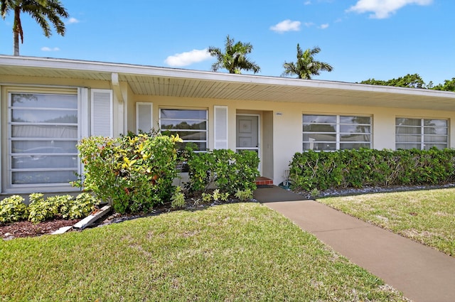 8644 Boca Dr, Boca Raton, FL 33433 - view of front of house featuring a front yard and stucco siding