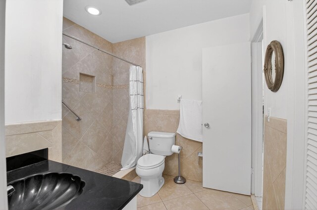 8644 Boca Dr, Boca Raton, FL 33433 - full bathroom with tile walls, tile patterned floors, tiled shower, a wainscoted wall, and a closet