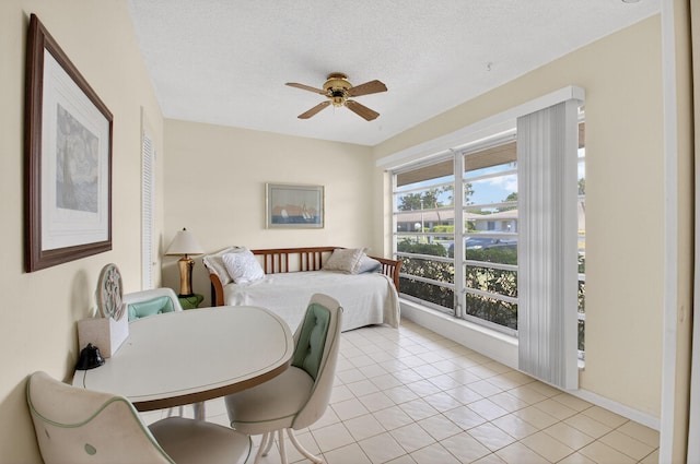 8644 Boca Dr, Boca Raton, FL 33433 - bedroom with light tile patterned floors, a ceiling fan, and a textured ceiling