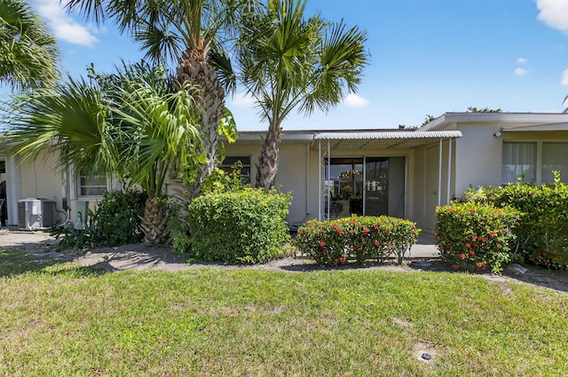 8644 Boca Dr, Boca Raton, FL 33433 - view of side of home with a lawn and stucco siding