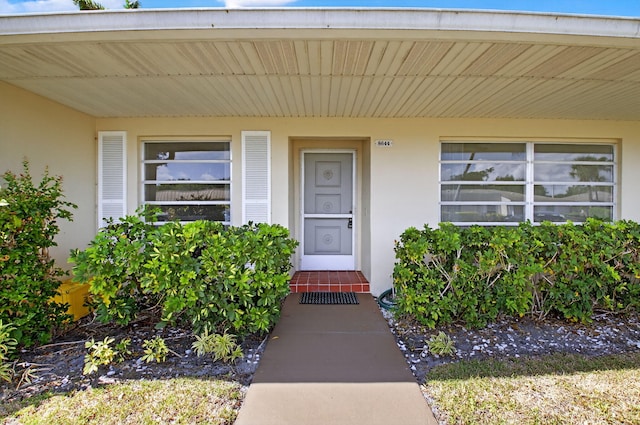 8644 Boca Dr, Boca Raton, FL 33433 - view of exterior entry with stucco siding and covered porch