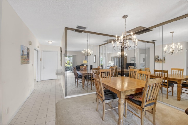 8644 Boca Dr, Boca Raton, FL 33433 - dining space featuring a chandelier, light tile patterned flooring, and a textured ceiling