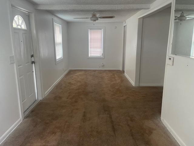 2618 Nokomis Ave, West Palm Beach, FL 33409 - carpeted foyer featuring a ceiling fan, baseboards, and a textured ceiling