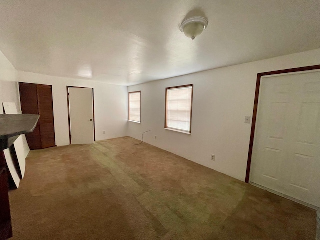 2618 Nokomis Ave, West Palm Beach, FL 33409 - unfurnished bedroom featuring light colored carpet and multiple closets