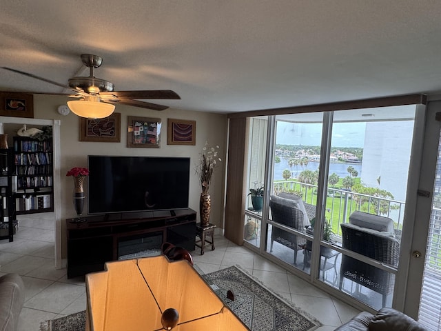336 Golfview Rd Unit 706, North Palm Beach, FL 33408 - living area featuring ceiling fan, light tile patterned floors, a wall of windows, and a textured ceiling