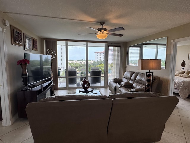 336 Golfview Rd Unit 706, North Palm Beach, FL 33408 - living area featuring light tile patterned flooring, a ceiling fan, plenty of natural light, and a textured ceiling