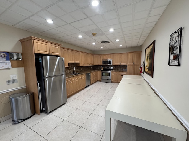 336 Golfview Rd Unit 706, North Palm Beach, FL 33408 - kitchen featuring stainless steel appliances, light tile patterned floors, backsplash, recessed lighting, and dark countertops