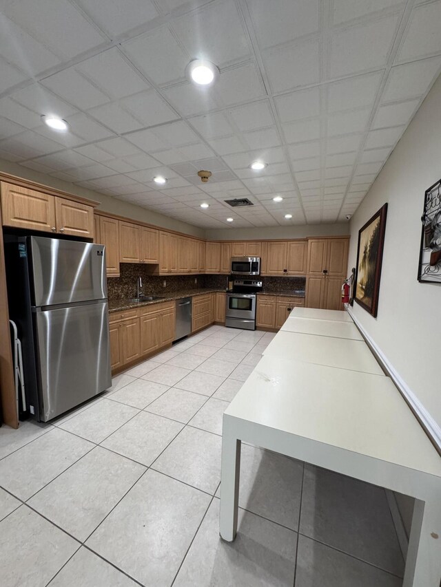 336 Golfview Rd Unit 706, North Palm Beach, FL 33408 - kitchen featuring appliances with stainless steel finishes, light tile patterned floors, tasteful backsplash, recessed lighting, and dark countertops