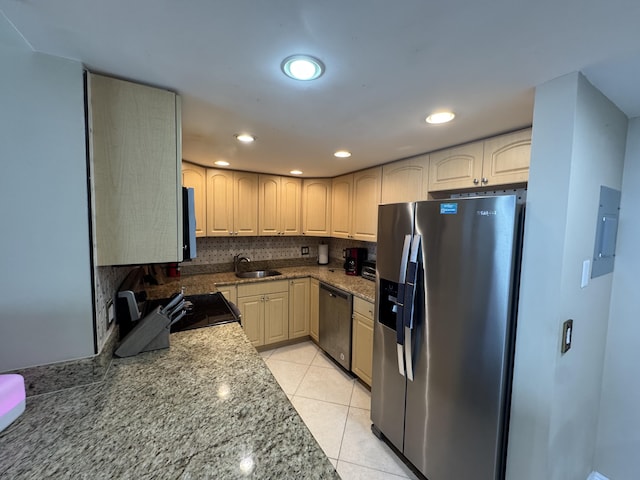 336 Golfview Rd Unit 706, North Palm Beach, FL 33408 - kitchen featuring appliances with stainless steel finishes, light tile patterned floors, backsplash, recessed lighting, and light stone counters