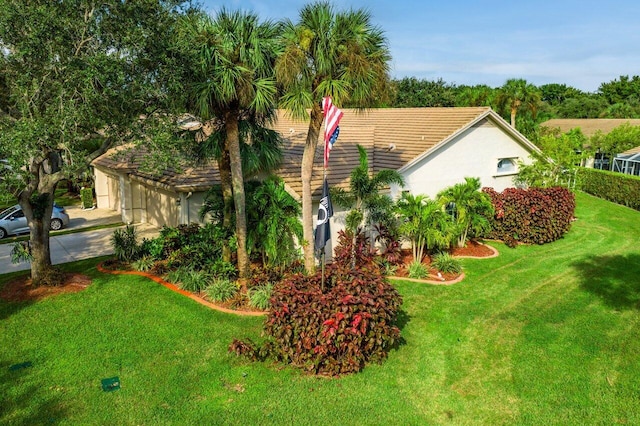 7465 Rockbridge Cir, Lake Worth, FL 33467 - view of home's exterior with a yard, stucco siding, a tiled roof, and a garage
