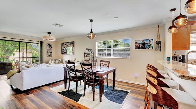 3001 W Linton Blvd Unit 204C, Delray Beach, FL 33445 - dining space with plenty of natural light, ornamental molding, wood finished floors, and baseboards