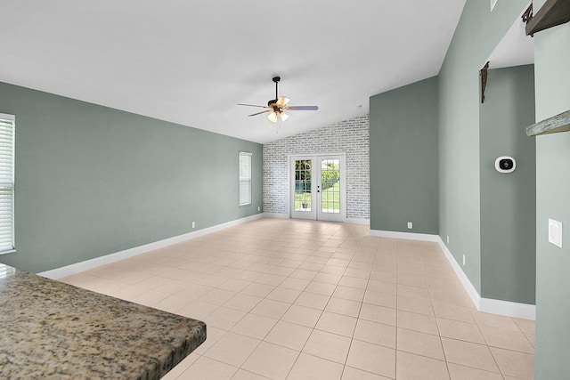 2867 SW Mustang Ter, Stuart, FL 34997 - unfurnished living room featuring a ceiling fan, vaulted ceiling, french doors, light tile patterned floors, and baseboards